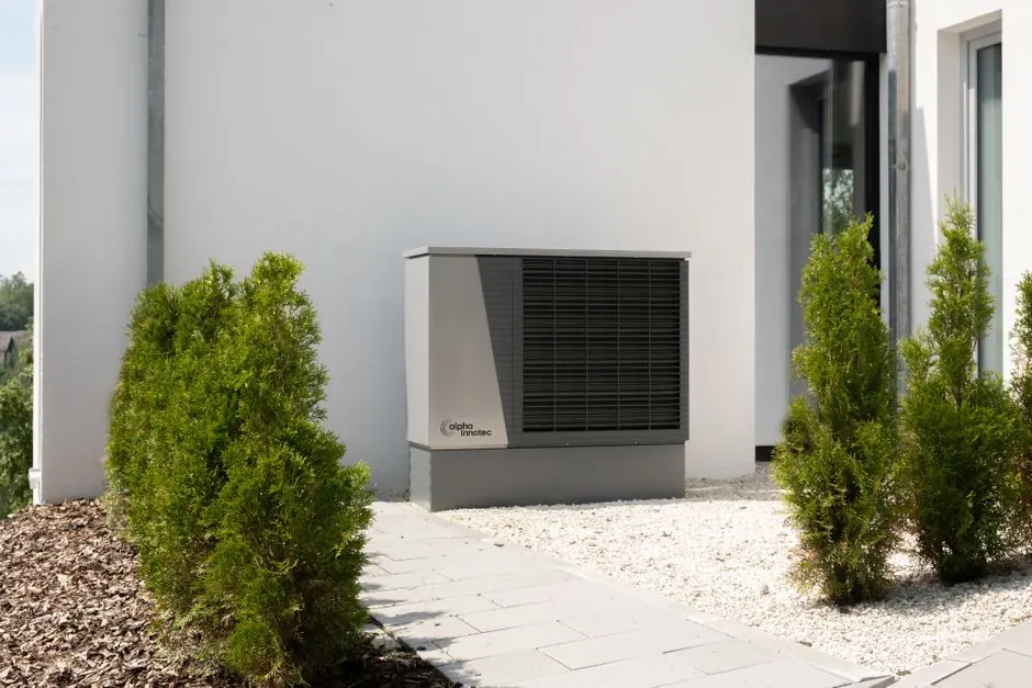 Outdoor unit of a heat pump at the facade of a detached house